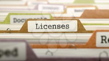 Licenses on Business Folder in Multicolor Card Index. Closeup View. Blurred Image.