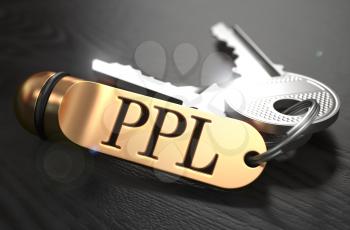 Keys and Golden Keyring with the Word PPL - Pay Per Lead  - over Black Wooden Table with Blur Effect.