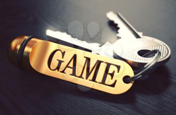Game - Bunch of Keys with Text on Golden Keychain. Black Wooden Background. Closeup View with Selective Focus. 3D Illustration. Toned Image.