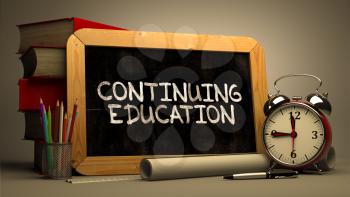 Hand Drawn Continuing Education Concept  on Chalkboard. Blurred Background. Toned Image.
