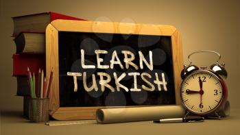 Hand Drawn Learn Turkish Concept  on Chalkboard. Blurred Background. Toned Image.