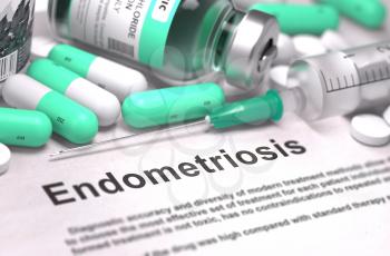 Endometriosis - Printed Diagnosis with Blurred Text. On Background of Medicaments Composition - Mint Green Pills, Injections and Syringe.