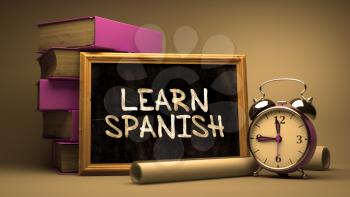 Learn Spanish Concept Hand Drawn on Chalkboard. Blurred Background. Toned Image.