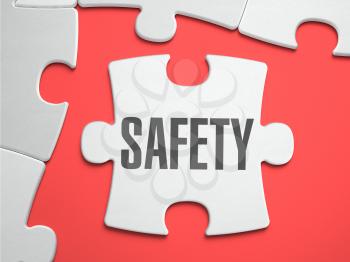 Safety - Text on Puzzle on the Place of Missing Pieces. Scarlett Background. Close-up. 3d Illustration.