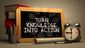 Turn Knowledge into Action. Handwritten Motivational Quote on Chalkboard. Composition with Chalkboard and Stack of Books, Alarm Clock and Scrolls on Blurred Background. Toned Image.