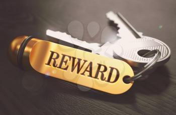 Keys with Word 'Reward on Golden Label over Black Wooden Background. Closeup View, Selective Focus, 3D Render. Toned Image.