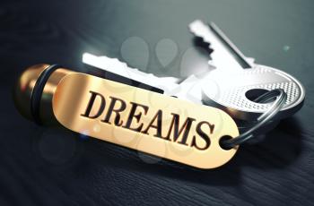 Keys to Dreams - Concept on Golden Keychain over Black Wooden Background. Closeup View, Selective Focus, 3D Render. Toned Image.