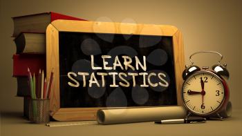 Learn Statistics - Inspirational Quote Hand Drawn on Chalkboard. Blurred Background. Toned Image.