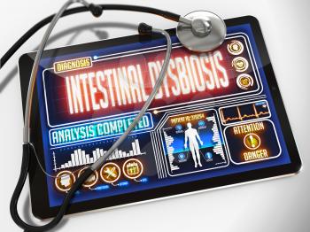 Intestinal Dysbiosis - Diagnosis on the Display of Medical Tablet and a Black Stethoscope on White Background.