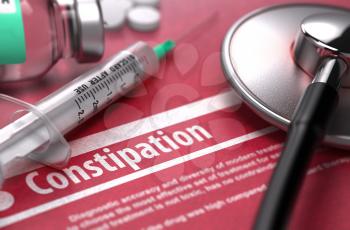 Constipation - Medical Concept on Red Background with Blurred Text and Composition of Pills, Syringe and Stethoscope.