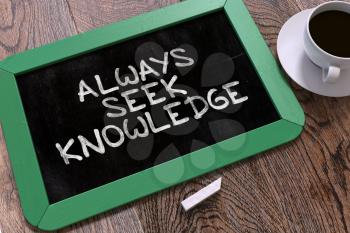 Always Seek Knowledge - Inspirational Quote Hand Drawn on Green Chalkboard on Wooden Table. Business Background. Top View.