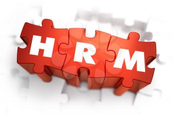 HRM - Human Resources Management - Text on Red Puzzles with White Background. 3D Render. 