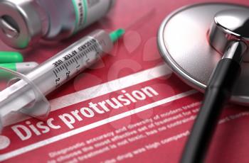 Disc protrusion - Medical Concept on Red Background with Blurred Text and Composition of Pills, Syringe and Stethoscope.