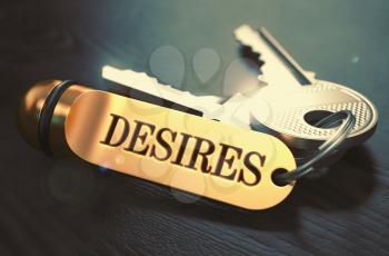 Keys and Golden Keyring with the Word Desires over Black Wooden Table with Blur Effect. Toned Image.