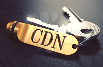 CDN - Content Delivery Networks - Bunch of Keys with Text on Golden Keychain. Black Wooden Background. Closeup View with Selective Focus. 3D Illustration. Toned Image.