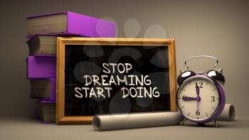 Hand Drawn Inspirational Quote - Stop Dreaming, Start Doing Concept  on Chalkboard. Blurred Background. Toned Image.
