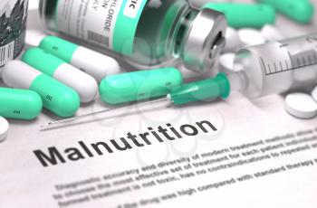 Malnutrition - Printed Diagnosis with Mint Green Pills, Injections and Syringe. Medical Concept with Selective Focus.