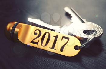2017 - Bunch of Keys with Text on Golden Keychain. Black Wooden Background. Closeup View with Selective Focus. 3D Illustration. Toned Image.