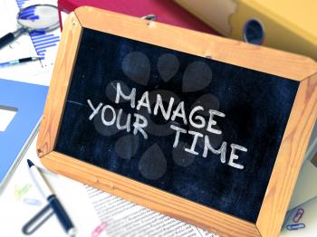 Manage Your Time. Motivational Quote on Chalkboard. Blurred Background. Toned Image.