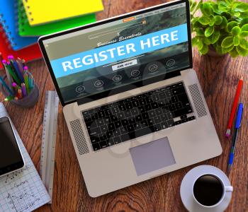 Register Here Concept. Modern Laptop and Different Office Supply on Wooden Desktop background.