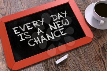 Hand Drawn Motivation Quote - Every Day is a New Chance - on Small Red Chalkboard. Business Background. Top View.