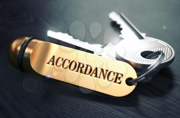 Keys with Word Accordance on Golden Label over Black Wooden Background. Closeup View, Selective Focus, 3D Render. Toned Image.