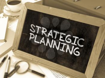 Hand Drawn Strategic Planning Concept  on Chalkboard. Blurred Background. Toned Image.