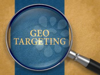 Geo Targeting through Magnifying Glass on Old Paper with Dark Blue Vertical Line Background.