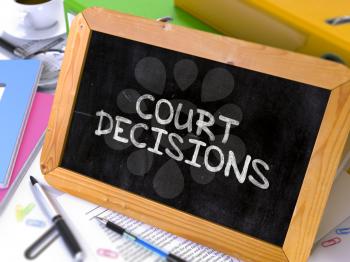 Handwritten Court Decisions on a Chalkboard. Composition with Chalkboard and Ring Binders, Office Supplies, Reports on Blurred Background. Toned Image.