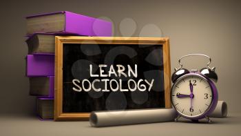 Hand Drawn Learn Sociology Concept  on Chalkboard. Blurred Background. Toned Image.