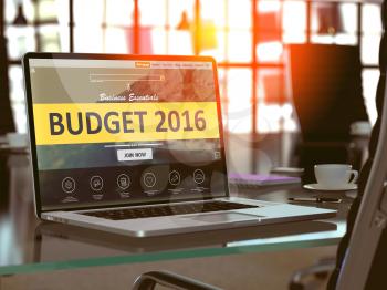 Modern Workplace with Laptop showing Landing Page with Budget 2016 Concept. Toned Image with Selective Focus.