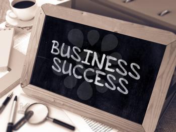Business Success Concept Hand Drawn on Chalkboard on Working Table Background. Blurred Background. Toned Image.