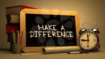 Make a Difference - Chalkboard with Hand Drawn Text, Stack of Books, Alarm Clock and Rolls of Paper on Blurred Background. Toned Image.
