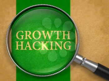 Growth Hacking through Loupe on Old Paper with Green Vertical Line Background.