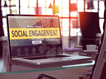 Social Engagement Concept. Closeup Landing Page on Laptop Screen  on background of Comfortable Working Place in Modern Office. Blurred, Toned Image.