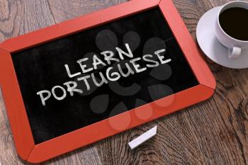 Learn Portuguese Concept Hand Drawn on Red Chalkboard on Wooden Table. Business Background. Top View. 3d Render.