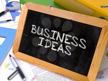 Business Ideas Concept Hand Drawn on Chalkboard on Working Table Background. Blurred Background. Toned Image.  3d Render.