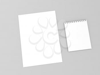 A sheet of paper and a notebook on a gray background. 3d render illustration.