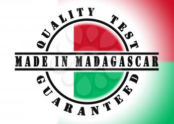 Quality test guaranteed stamp with a national flag inside, Madagascar
