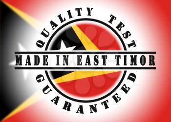 Quality test guaranteed stamp with a national flag inside, East Timor