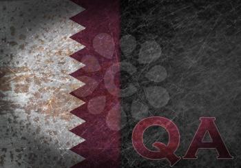 Old rusty metal sign with a flag and country abbreviation - Qatar