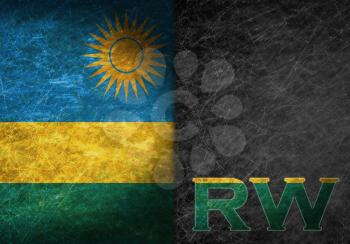 Old rusty metal sign with a flag and country abbreviation - Rwanda