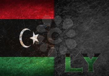 Old rusty metal sign with a flag and country abbreviation - Libya