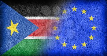 South Sudan and the EU, flags painted on cracked concrete