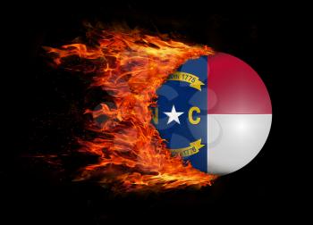 Concept of speed - US state flag with a trail of fire - North Carolina
