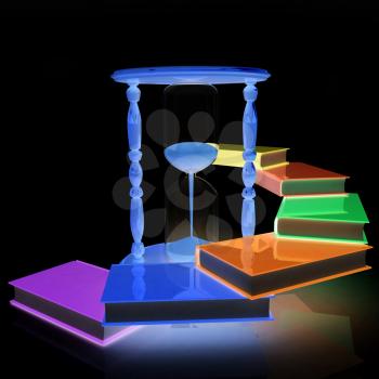 Hourglass and books on a black background