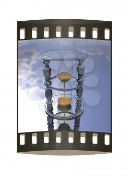 Chrome hourglass on a chrome reflective background. The film strip