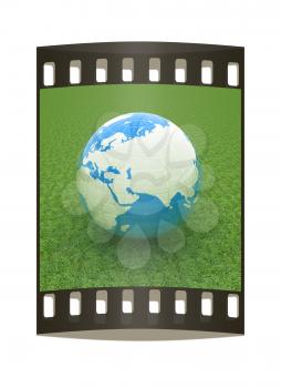 Earth on green grass. Abstract 3d illustration. The film strip