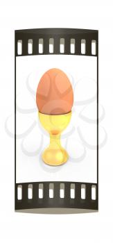 Easter egg on gold egg cups on a white background. The film strip with place for your text