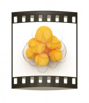 Oranges on a glass plate on a white background. The film strip